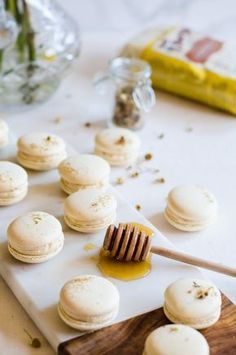 a table topped with macaroons covered in honey