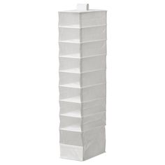 a tall white storage tower with six shelves on each side and two candles in the middle