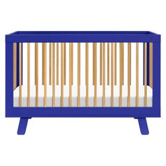 a blue crib with wooden slats and white sheets on the bottom, in front of a white background