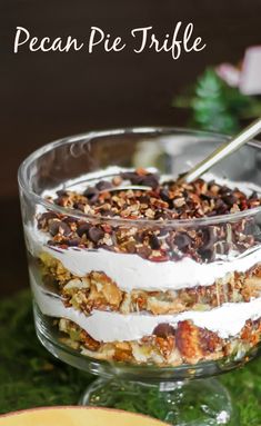 a glass bowl filled with food sitting on top of a green tablecloth next to a plate