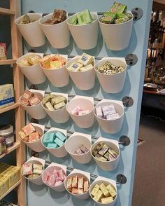 several buckets filled with different types of candy on display in a store's deli