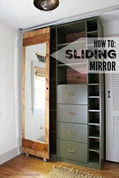 an open closet with sliding doors and mirror on the wall, in front of a wooden floor