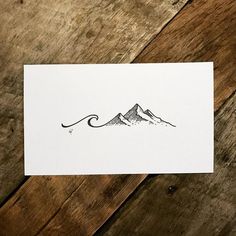 a card with a drawing of mountains on it