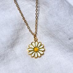 This necklace features an enamel 14x17mm daisy charm attached to a 16" chain. All materials are 24k gold plated, tarnish resistant, lead, and nickel free. Matching earrings available here. Full necklace and earrings set available here. 70s Jewelry Necklaces, Cute Gold Jewelry With Flower Charm, Everyday Gold Enamel Jewelry, Trendy White Enamel Jewelry, Yellow Flower Shaped Jewelry With Adjustable Chain, Cute Gold Enamel Jewelry, Trendy White Flower Necklace As Gift, Trendy White Flower Necklace For Gift, Trendy White Flower Necklace Gift