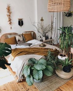 a bedroom with lots of plants on the floor