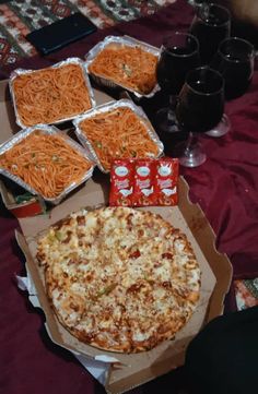 several pizzas and drinks on a table