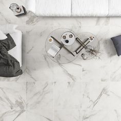 an overhead view of a bedroom with marble flooring and white bedding on the side