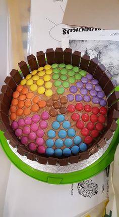 there is a cake made out of chocolate and colored candy eggs in the middle of it