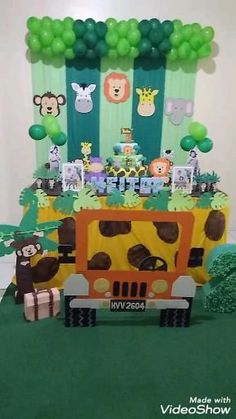 an animal themed birthday party with jungle animals and safari vehicles on the front, balloons in the background