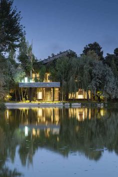 the house is surrounded by trees and water