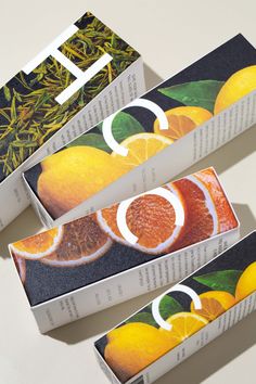 three boxes with oranges on them sitting next to each other