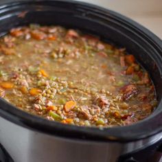 a slow cooker filled with meat and vegetables