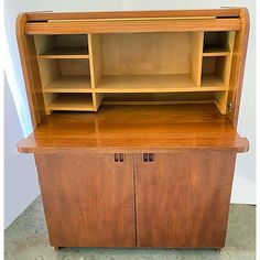 an old wooden cabinet with shelves and cupboards