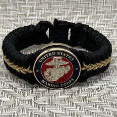 This is an officer Marine Corps paracord bracelet. Silver and gold plated Eagle Globe and Anchor. Makes a perfect USMC gift for any veteran or active duty Marine. Marine Moms and Dads will love this bracelet too. Unique top shelf quality jewelry. Great retirement gift. Semper fi. *Silver & gold plated officer Eagle Globe & Anchor *1 1/4" wide USMC medallion. Only 9mm thick *3/4" wide weave *Very sturdy and durable *Quality Cobra tactical buckle *Very comfortable *I am an official USMC licensee; Usmc Retirement, Usmc Gifts, Eagle Globe Anchor, Eagle Globe And Anchor, 550 Cord, Military Gift, Marine Mom, Semper Fi, Military Gifts