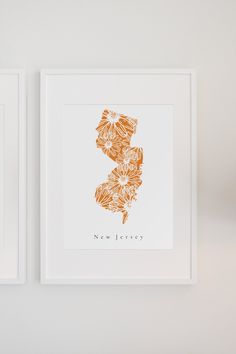 two framed art pieces on a wall with the word new jersey printed in orange and white