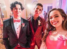 three young people in formal wear posing for a photo