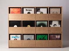 a wooden shelf filled with cd's and cds