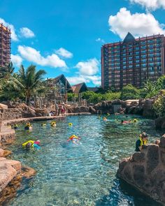 people are swimming in the water near hotels