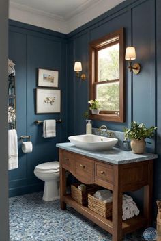 a bathroom with blue walls and white fixtures, including a wooden vanity sink countertop