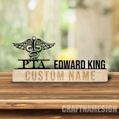 a wooden table with a stethoscope and the words pta edward king custom name on it