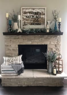 a living room with a fire place and some decorations on top of the mantel