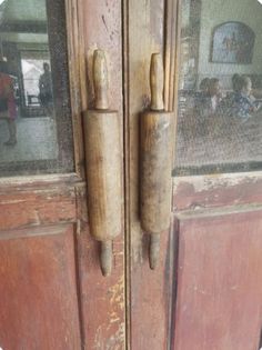 an old wooden door with two handles on it