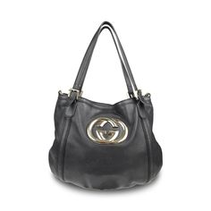 Gucci 'Britt' hobo bag in black smooth leather with with a large GG plaque in gold hardware. Features dual top buckle handles and a detachable crossbody strap. Brand = Gucci Condition = 7/10, Good. Some wear to leather body, scratching in metal hardware, wear to crossbody strap Dimensions = 16" x 13" x 0.25" top Handle = 9.5" Strap Drop = 12' Material = Leather Hardware = Soft Gold SKU = 10806-68 Gucci Bag With Gold-tone Hardware And Top Handle, Gucci Top Handle Bag With Gold-tone Hardware, Gucci Top Handle Bag With Branded Hardware, Gucci Top Handle Bag With Logo, Gucci Crossbody Satchel With Gold-tone Hardware, Gucci Shoulder Bag With Gold-tone Hardware For Shopping, Gucci Tote Bag With Branded Hardware, Gucci Double Handle Bags With Gold-tone Hardware, Gucci Satchel With Detachable Strap For Shopping