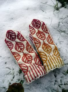 two knit mittens laying in the snow