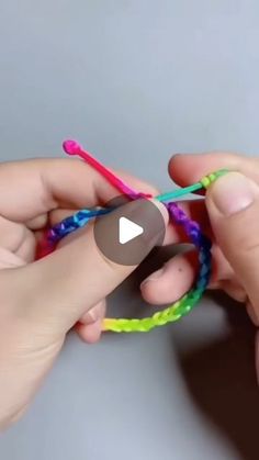 two hands holding crochet hooks in each other's fingers