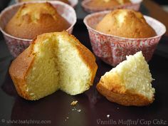 several muffins with one cut in half on a black plate and the other partially eaten