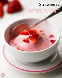 a bowl of frozen yogurt with strawberries on top