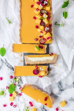 slices of cheese and fruit on bread with pomegranates