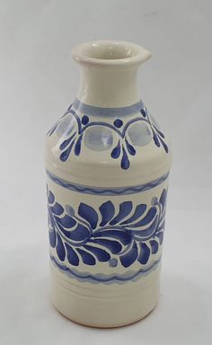 a blue and white vase sitting on top of a table