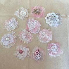 many different types of laces and bows on a table cloth with buttons in the middle