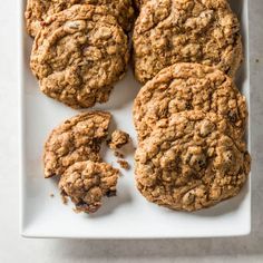 four oatmeal cookies on a white plate