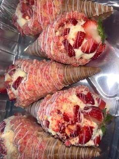 strawberries are wrapped in ice cream and garnished with green leaves