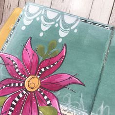 a close up of a book with flowers painted on it