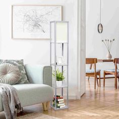 a living room filled with furniture and a white book shelf next to a chair on top of a hard wood floor