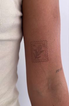 a woman's arm with a stamp on it that has a flower in it