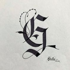 the letter e is made up of black ink and has an intricate design on it