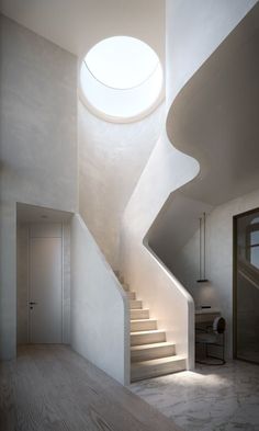 an empty room with stairs leading up to the skylight