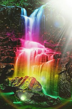 an image of a waterfall with rainbow colors in the water and light coming from it