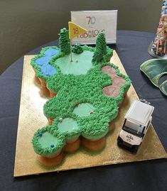 a golf themed cake on a table with a toy car parked in front of it