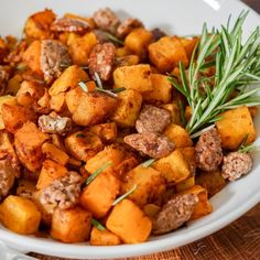 a white bowl filled with meat and vegetables