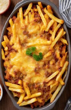 a casserole dish filled with cheesy french fries