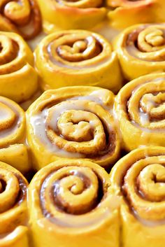 there are many cinnamon rolls with icing on them