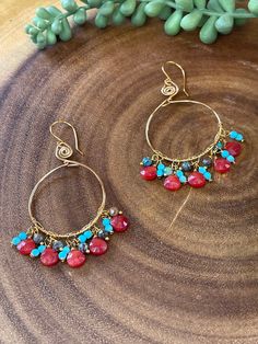 These exquisite hoop earrings are created with a blend of carnelian, turquoise, and blue jasper gemstones, resulting in a beautiful array of colors. The frames and ear hooks are expertly crafted from non-tarnish gold brass, providing enduring beauty. With a 1.25 inch diameter and a length of almost 3 inches, these earrings offer both fashion and exceptional craftsmanship. Blue Jasper, Gemstone Hoop Earrings, Gold Brass, Ear Hook, Jasper Gemstone, Gemstone Earrings, Hoop Earrings, Thing 1, Turquoise