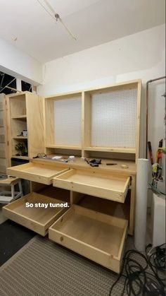 an unfinished workbench with drawers and shelves