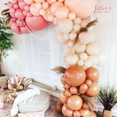 a bunch of balloons hanging from the side of a wall next to a potted plant