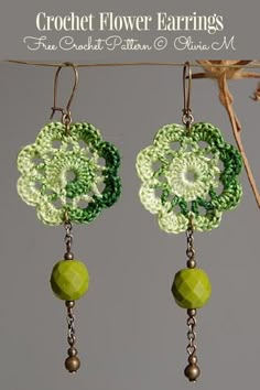 crochet flower earrings with green beads hanging from the earwires on a branch